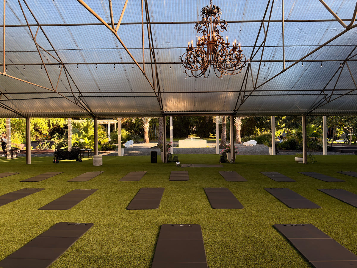 Rooftop Pilates class on mats overlooking the water in Tampa Bay with Club Sweat
