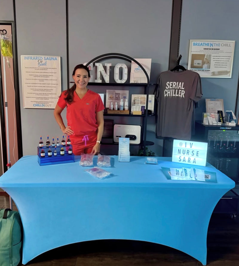 Nurse at the Tampa Mobile IV Therapy table set up for a Club Sweat event